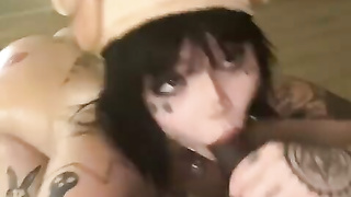 tattooed woman sucking a black cock